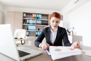 woman searching through business documents