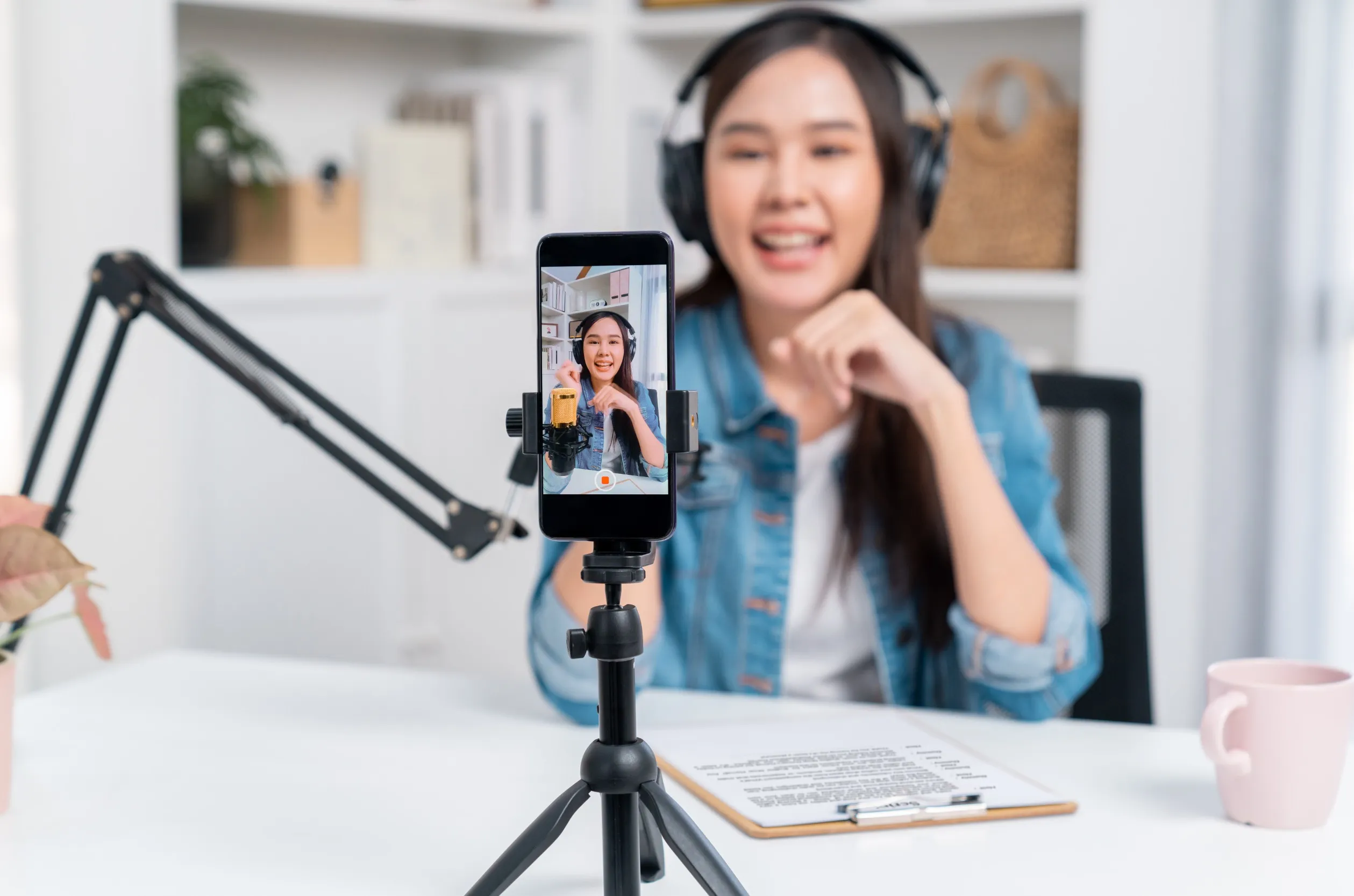 A woman recording a video of herself on mobile for TikTok