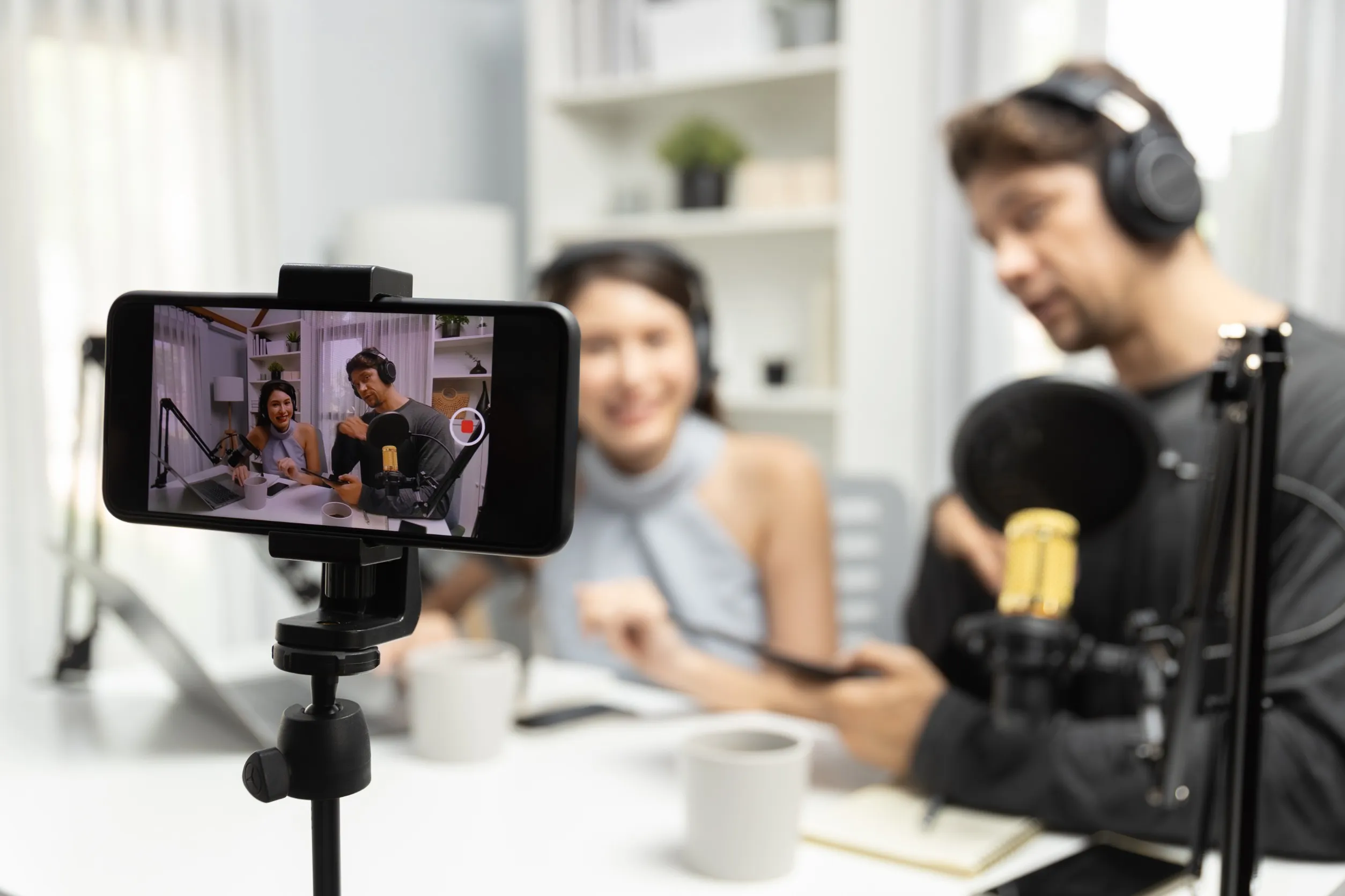 Coworkers recording a podcast for social media content